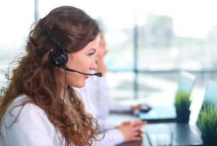 smiling female customer service agent on the phone